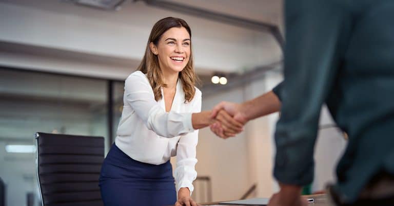 Friendly exchange and shaking hands in office