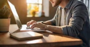 Young man using laptop at desk